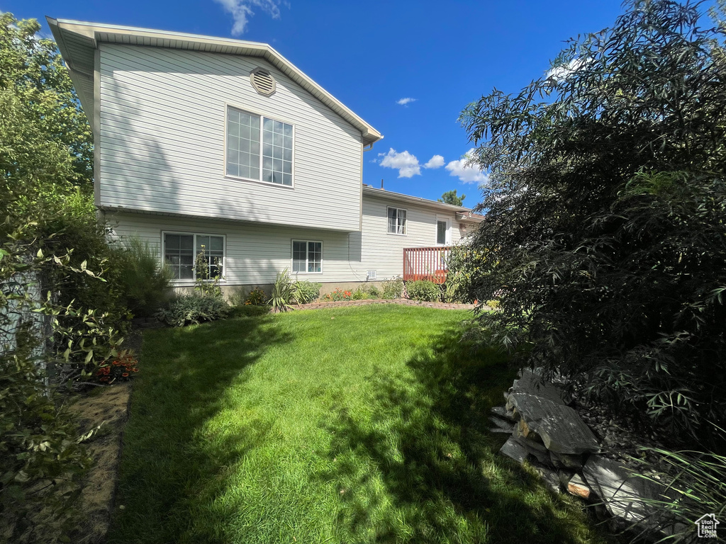 Rear view of property featuring a yard