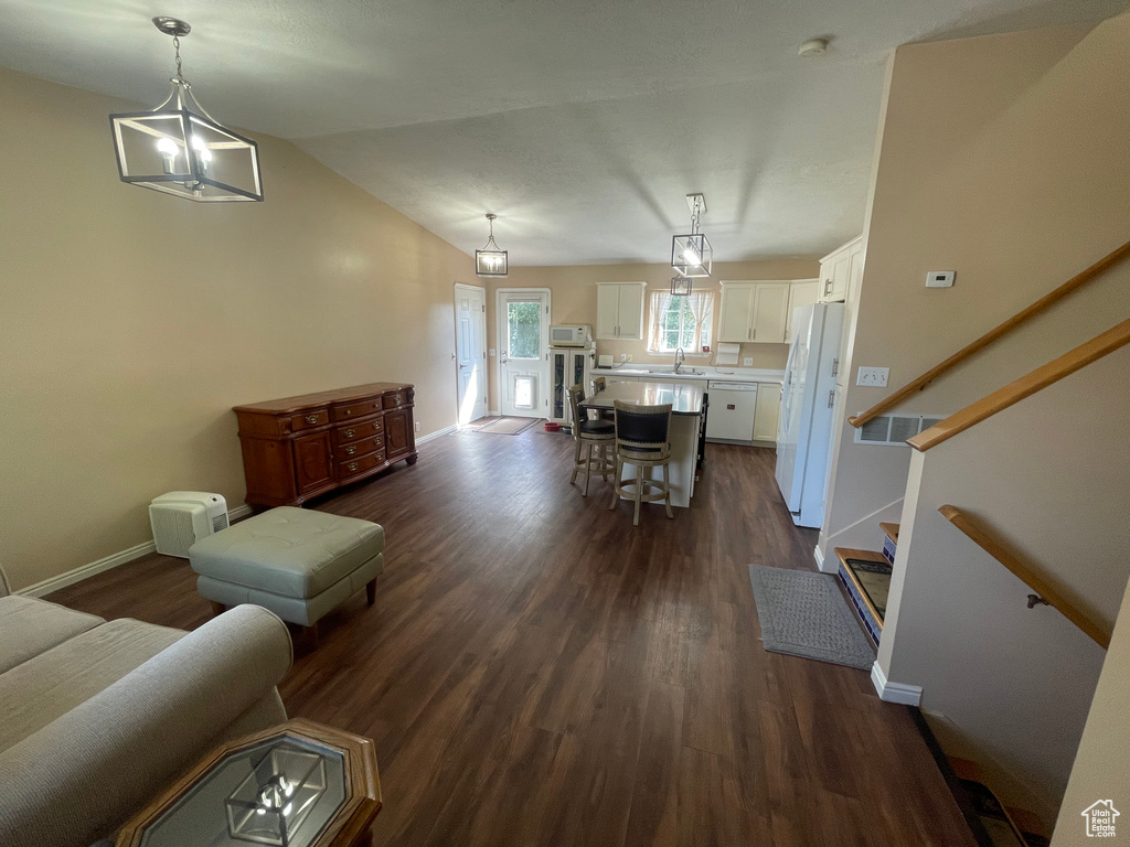 Living room featuring sink and dark hardwood / wood-style flooring