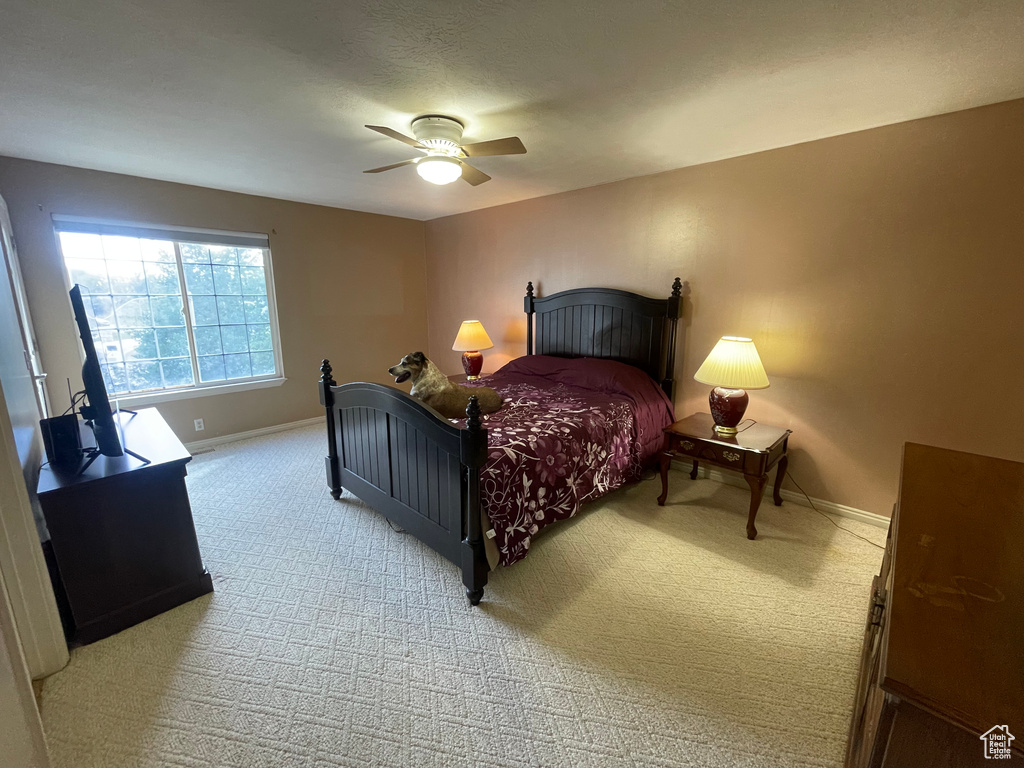 Bedroom featuring light colored carpet and ceiling fan