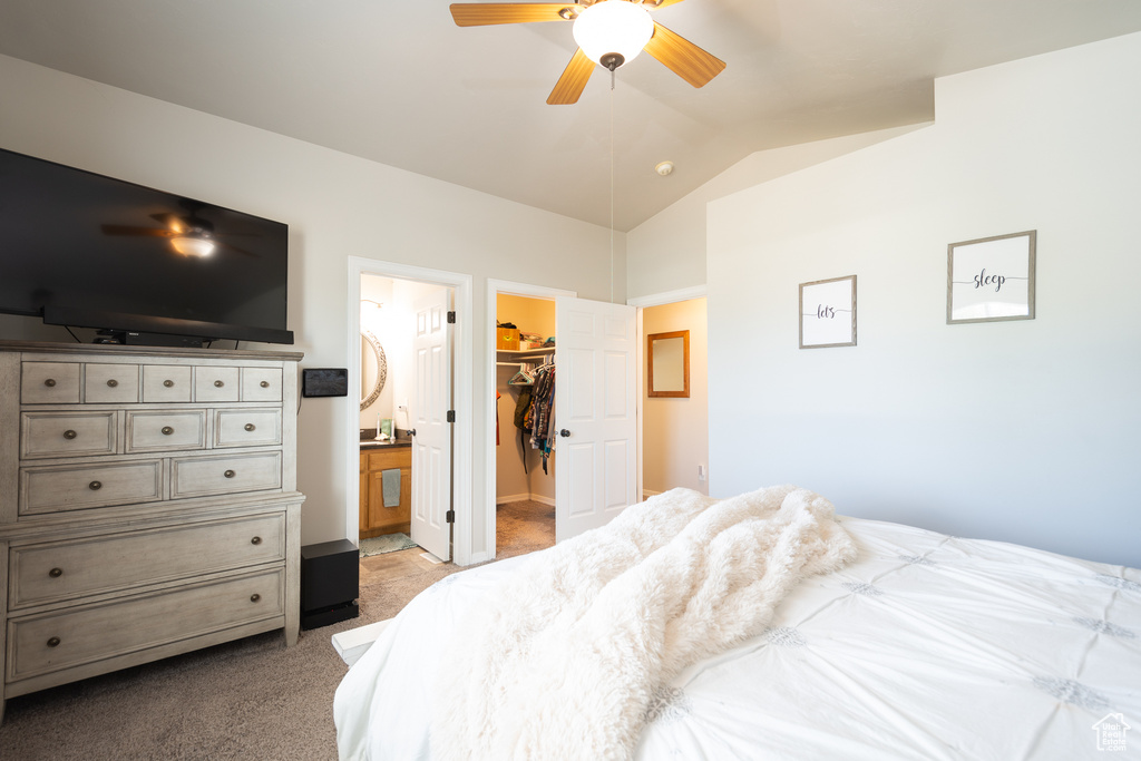 Bedroom with carpet, lofted ceiling, a spacious closet, a closet, and ensuite bathroom