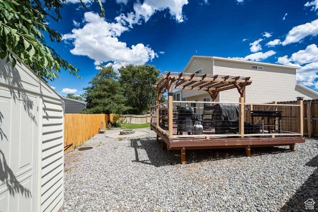 View of yard with a pergola and a wooden deck