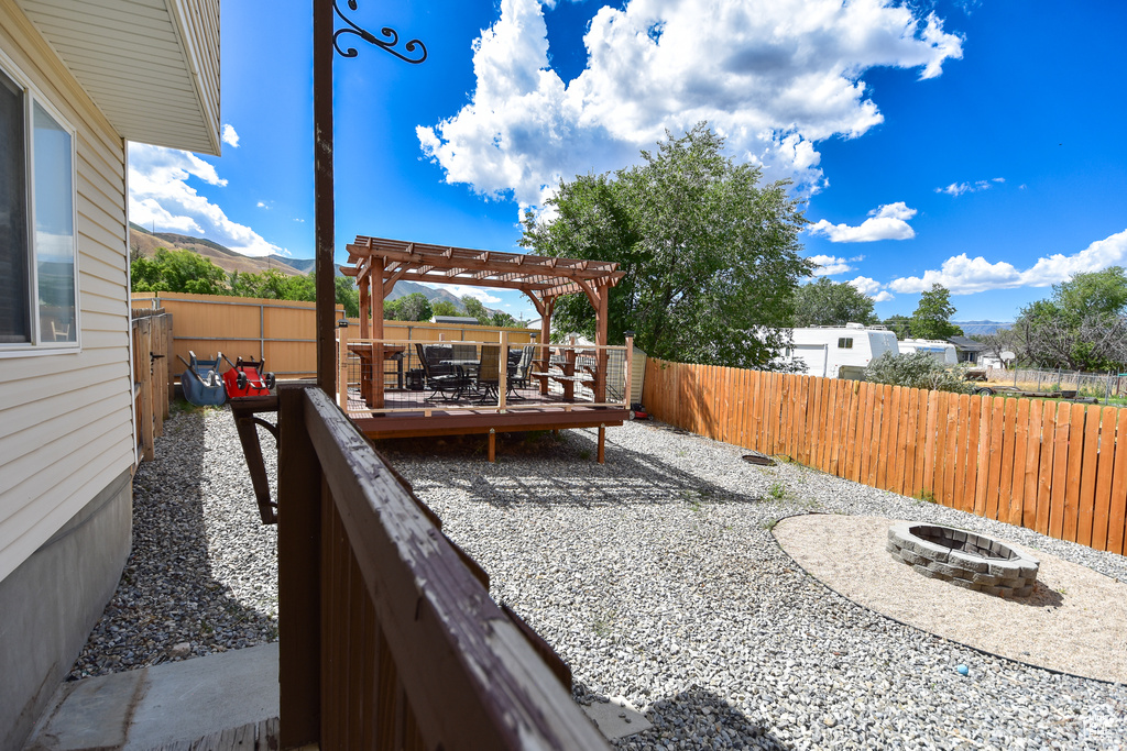 View of patio / terrace with a pergola and a fire pit