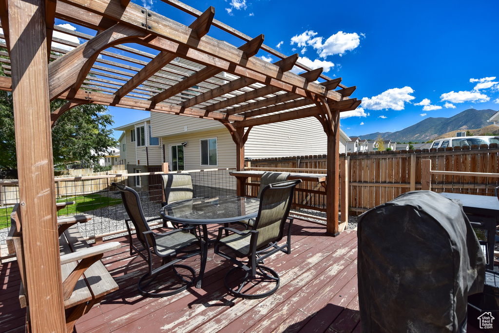 Wooden terrace featuring a pergola, a mountain view, and a grill