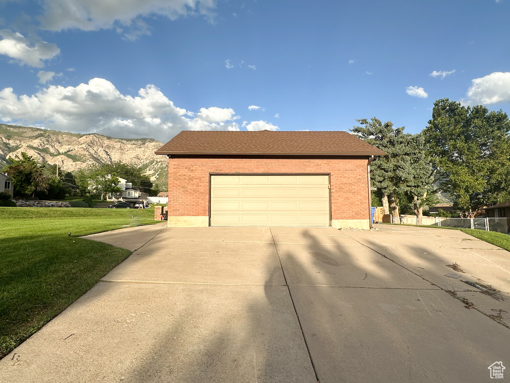 Exterior space with a mountain view and a yard