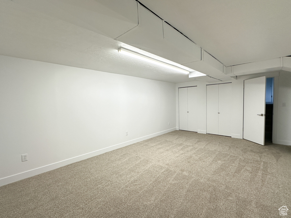 Basement with light colored carpet