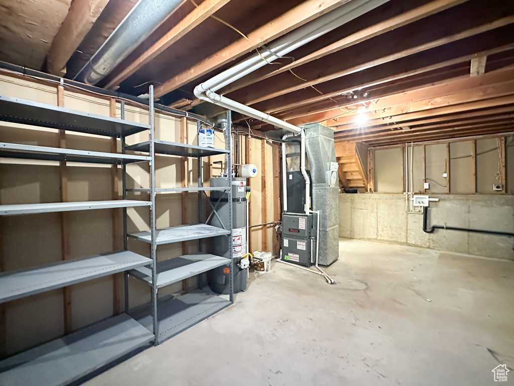 Basement featuring gas water heater and heating unit