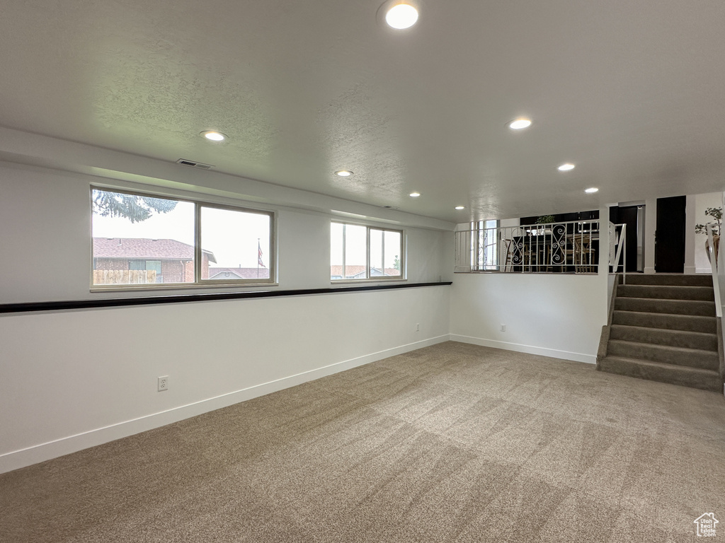 Interior space featuring carpet and a textured ceiling