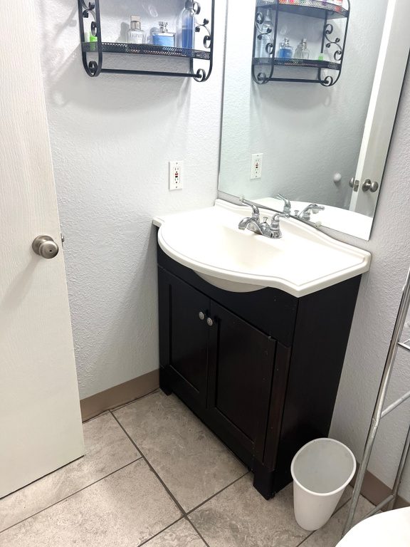 Bathroom featuring tile patterned flooring and vanity