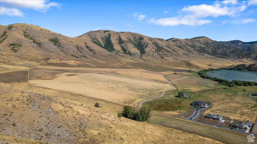 Property view of mountains featuring a rural view and a water view