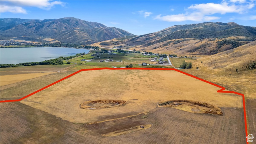 Birds eye view of property featuring a water and mountain view