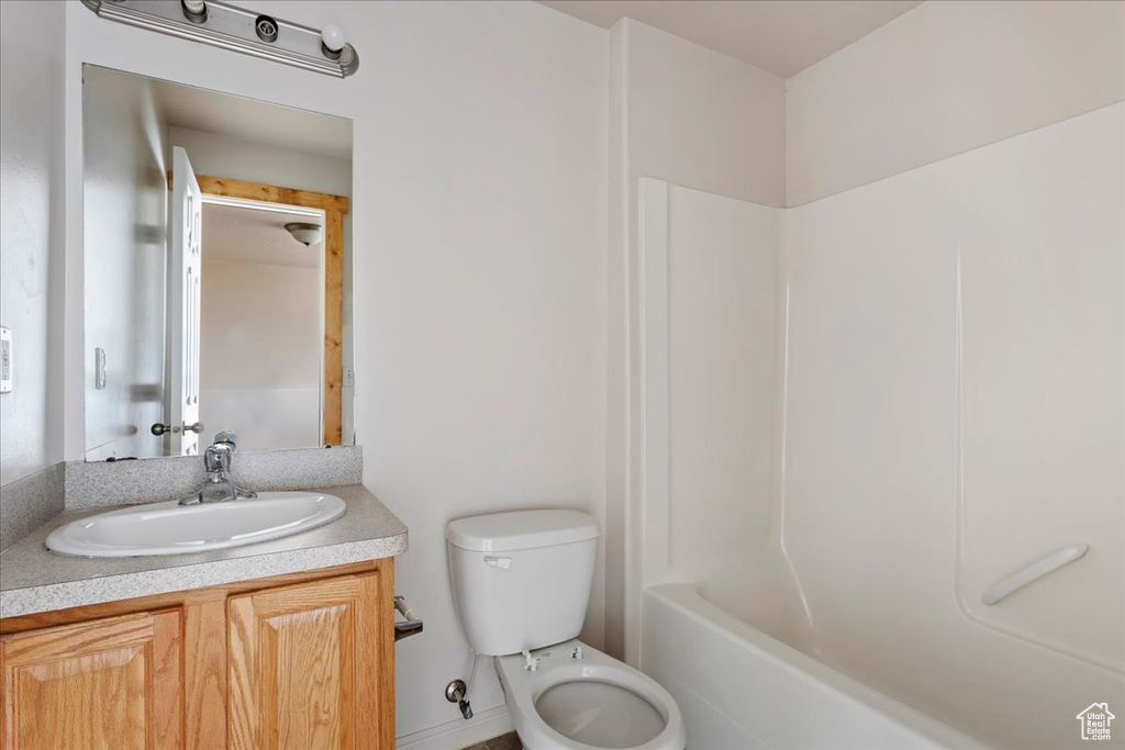 Full bathroom featuring bathtub / shower combination, vanity, and toilet