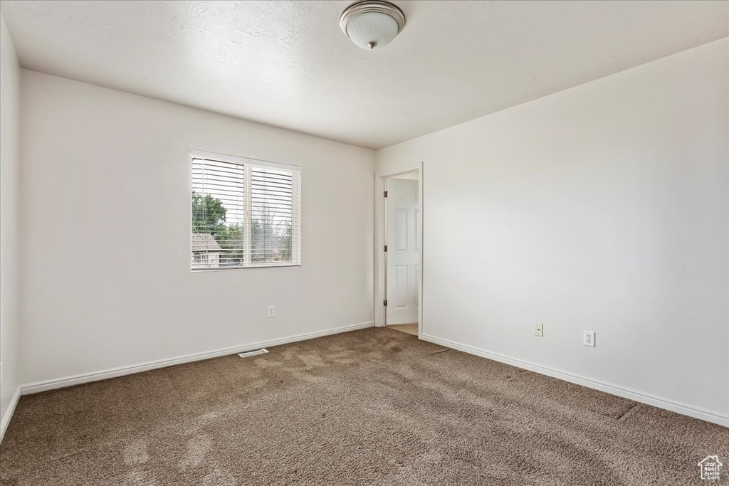 Empty room with carpet flooring