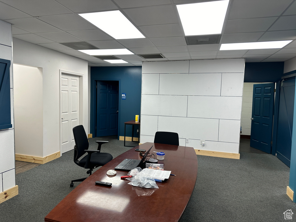 Carpeted office featuring a drop ceiling