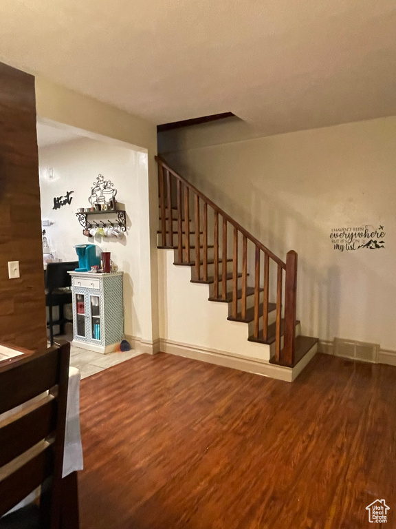 Stairs featuring hardwood / wood-style floors