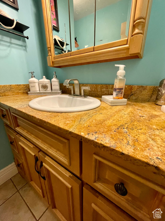Bathroom featuring tile patterned flooring and vanity