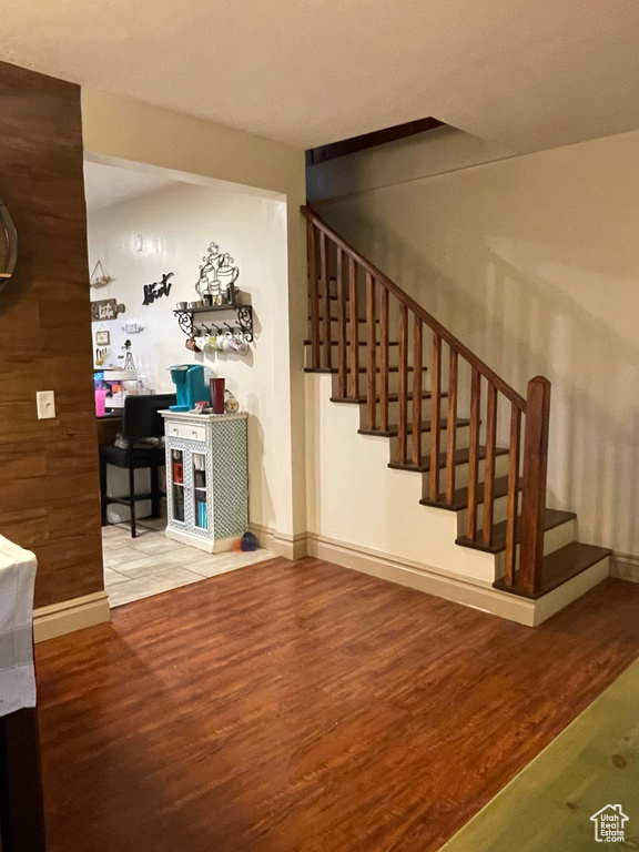 Stairway featuring hardwood / wood-style flooring