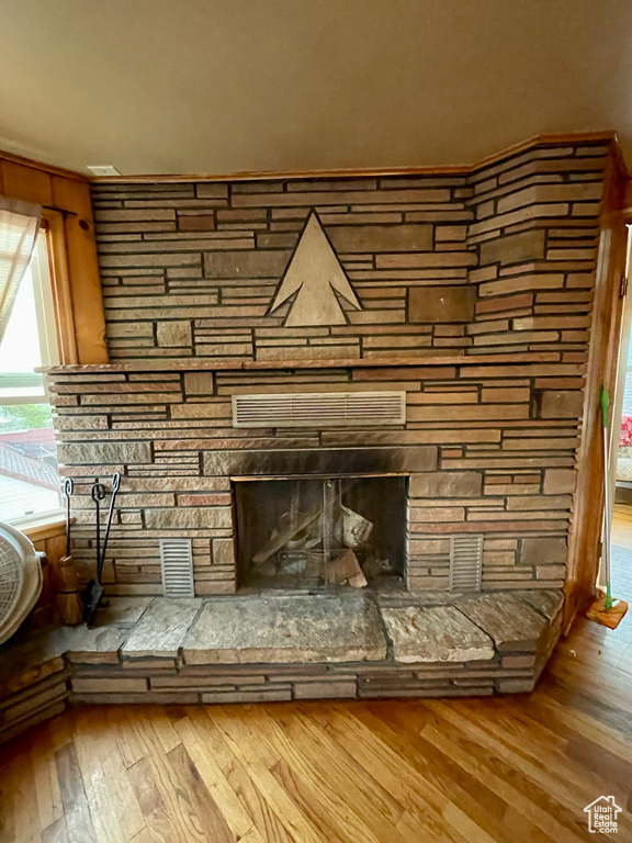 Room details featuring a fireplace and hardwood / wood-style floors