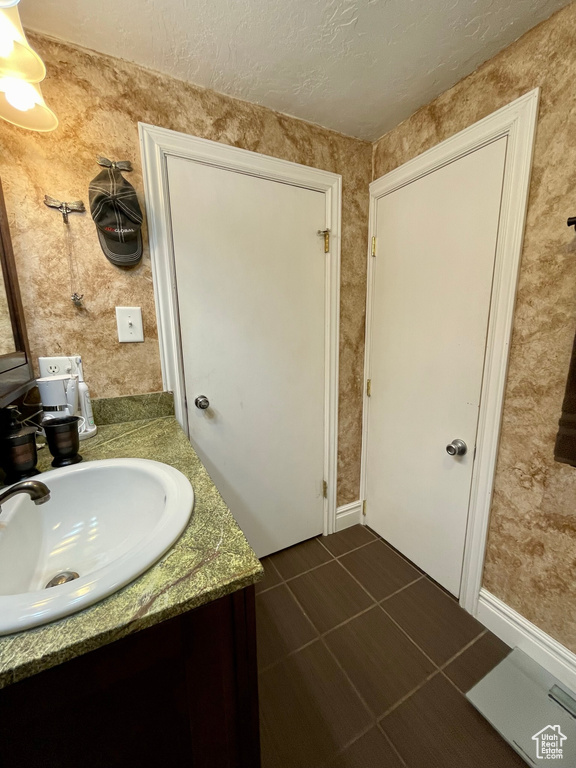 Bathroom with tile patterned flooring and vanity