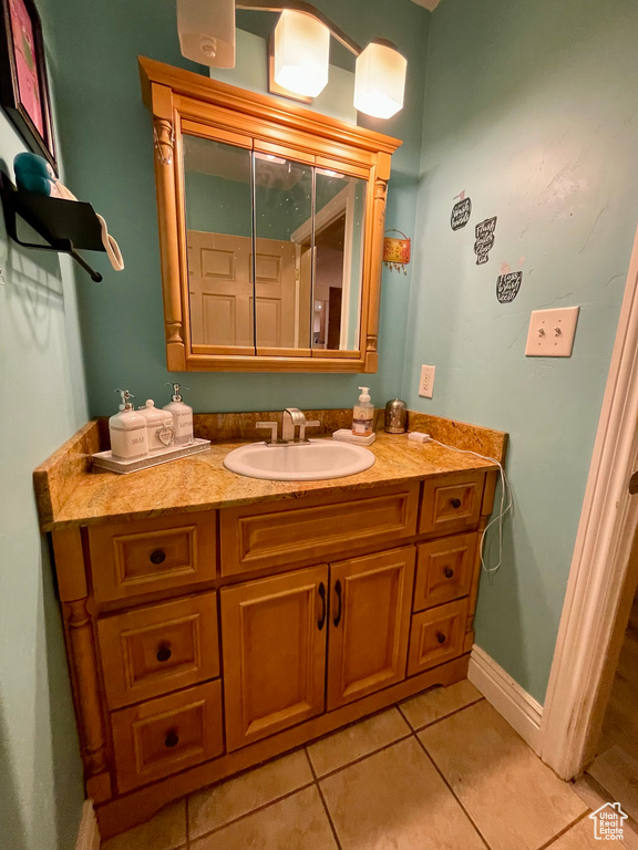Bathroom featuring tile patterned flooring and vanity
