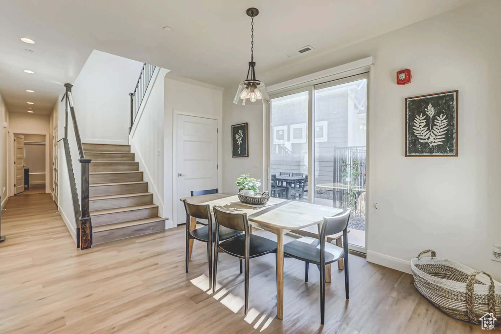 Dining area with light hardwood / wood-style flooring