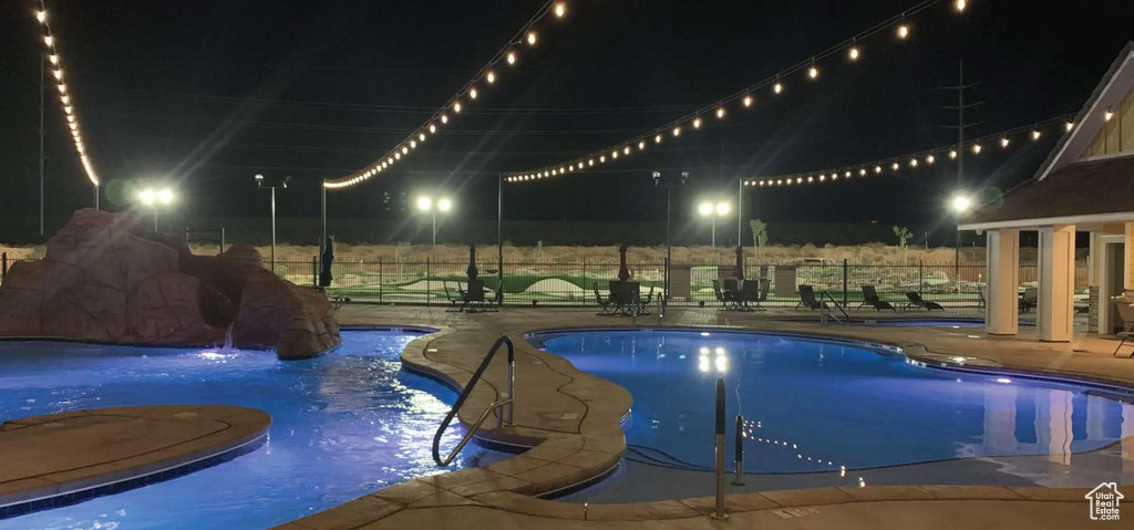 Pool at twilight featuring a patio