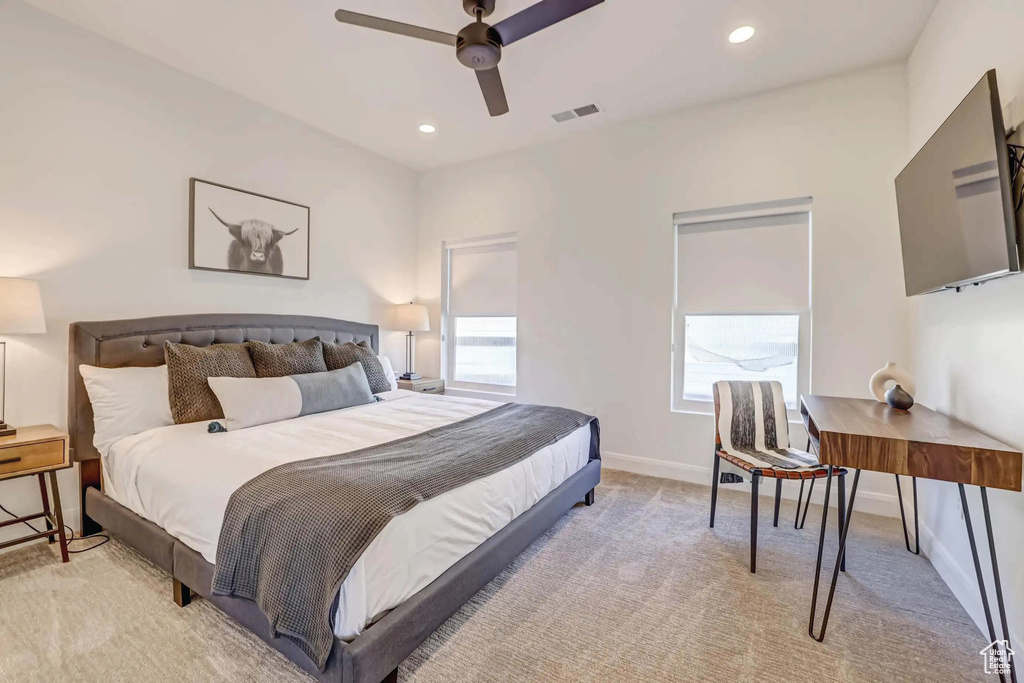Carpeted bedroom featuring ceiling fan