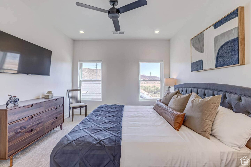 Carpeted bedroom featuring ceiling fan