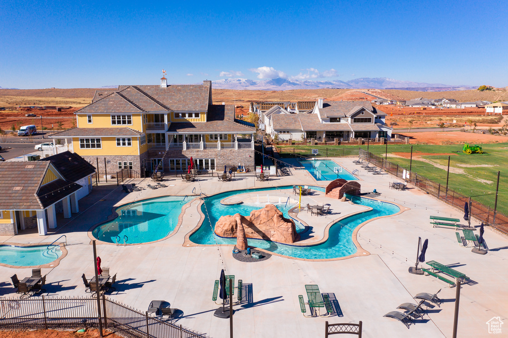 View of pool with a water slide and a patio