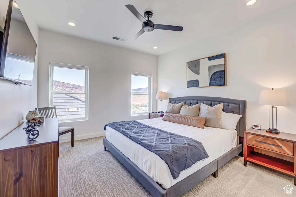 Carpeted bedroom with ceiling fan