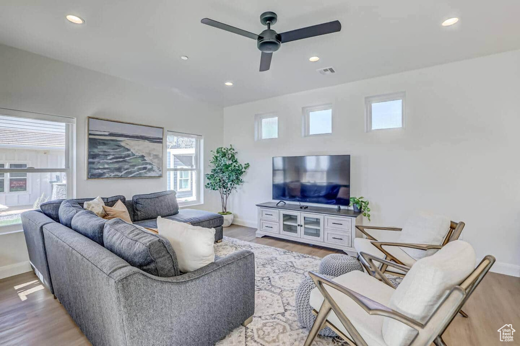 Living room with ceiling fan and wood-type flooring
