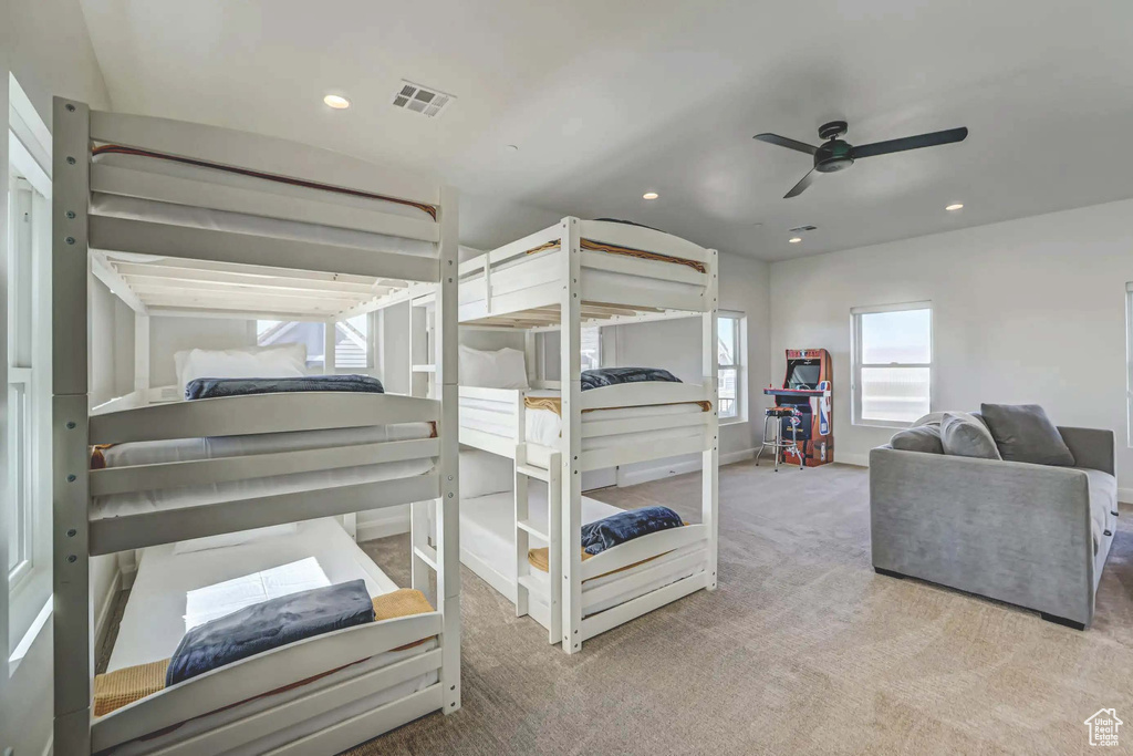 Carpeted bedroom featuring ceiling fan