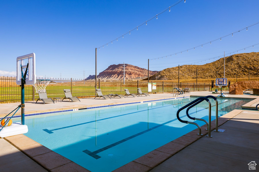 View of pool featuring a mountain view and a patio