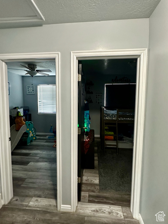 Corridor featuring hardwood / wood-style floors and a textured ceiling