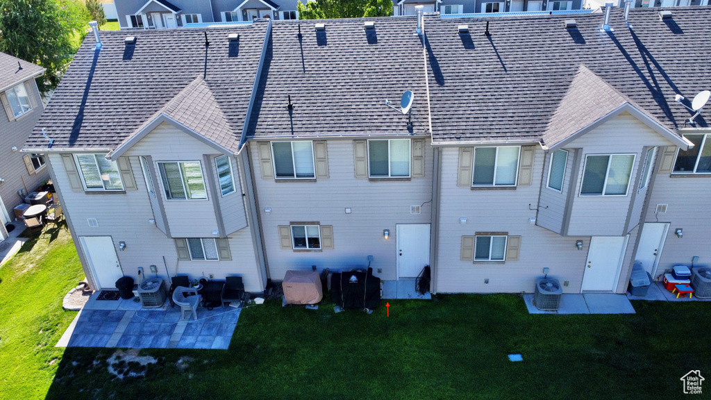 Back of property with a patio and a yard