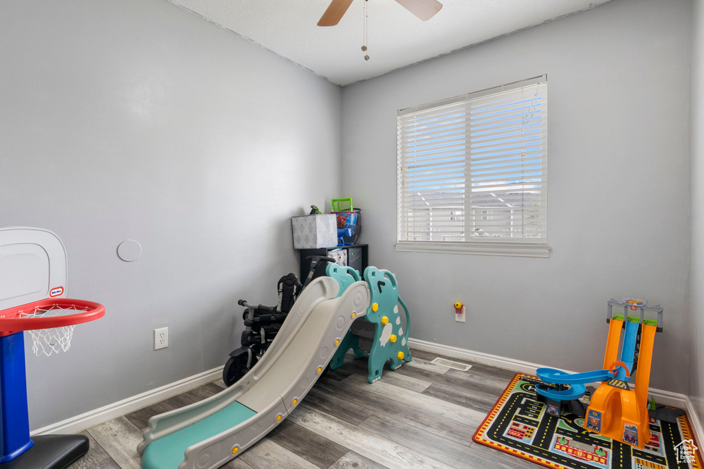 Playroom with light wood-type flooring and ceiling fan