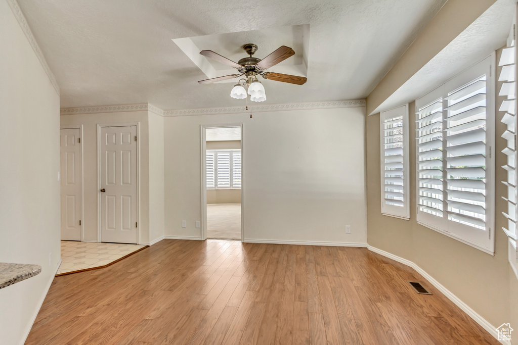 Empty room featuring ceiling fan and light wood-type flooring