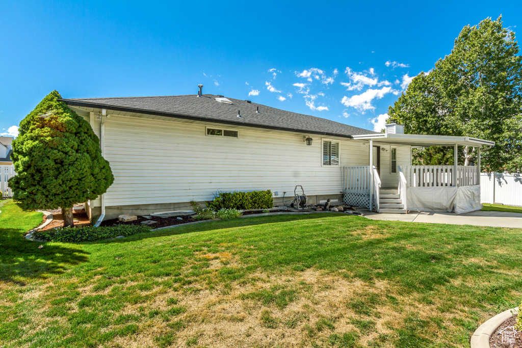 Back of house featuring a patio area and a lawn