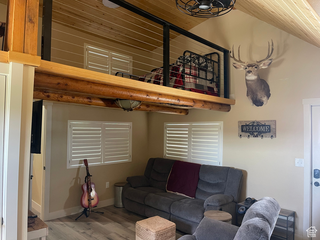 Living room with wooden ceiling and hardwood / wood-style floors