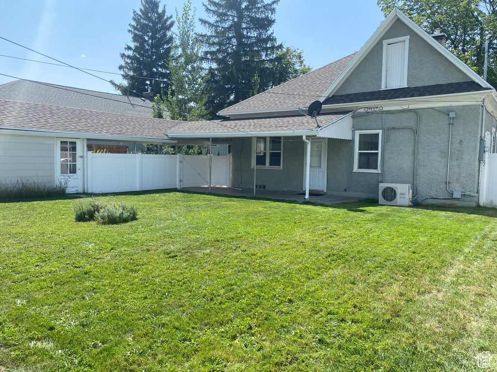 Rear view of property featuring a yard