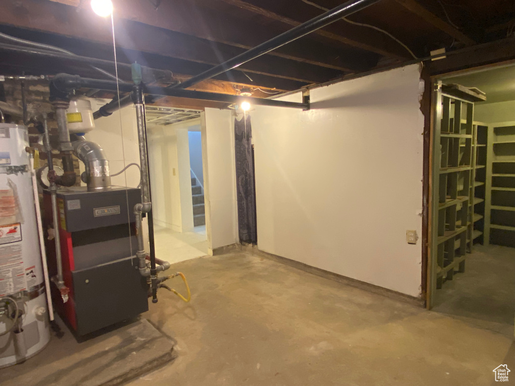 Basement featuring gas water heater and heating unit