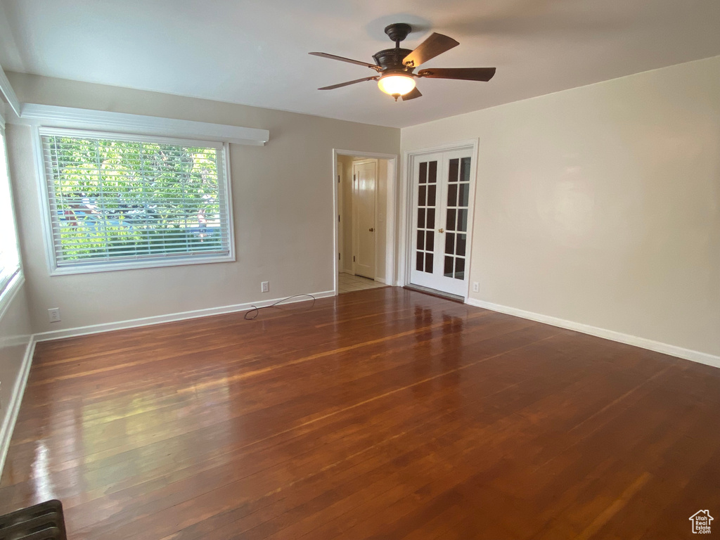 Unfurnished room with dark hardwood / wood-style floors and ceiling fan