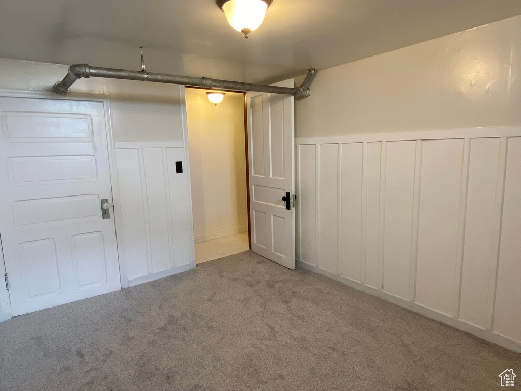 Basement featuring light colored carpet