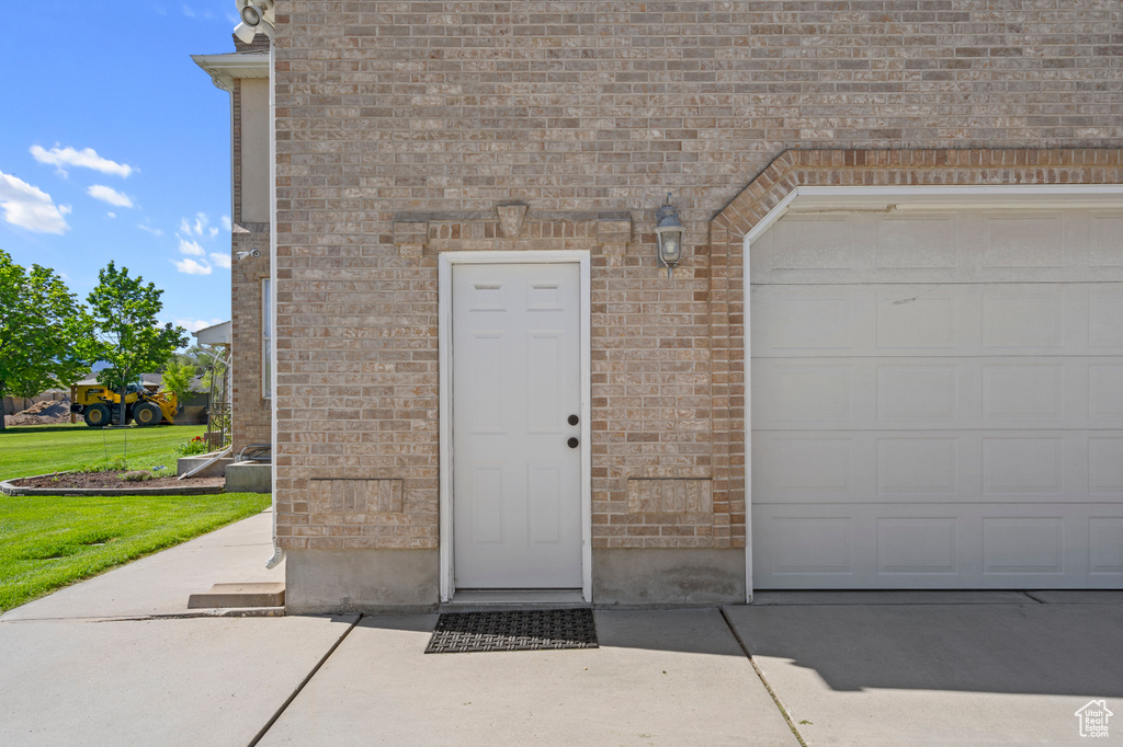 View of exterior entry with a garage