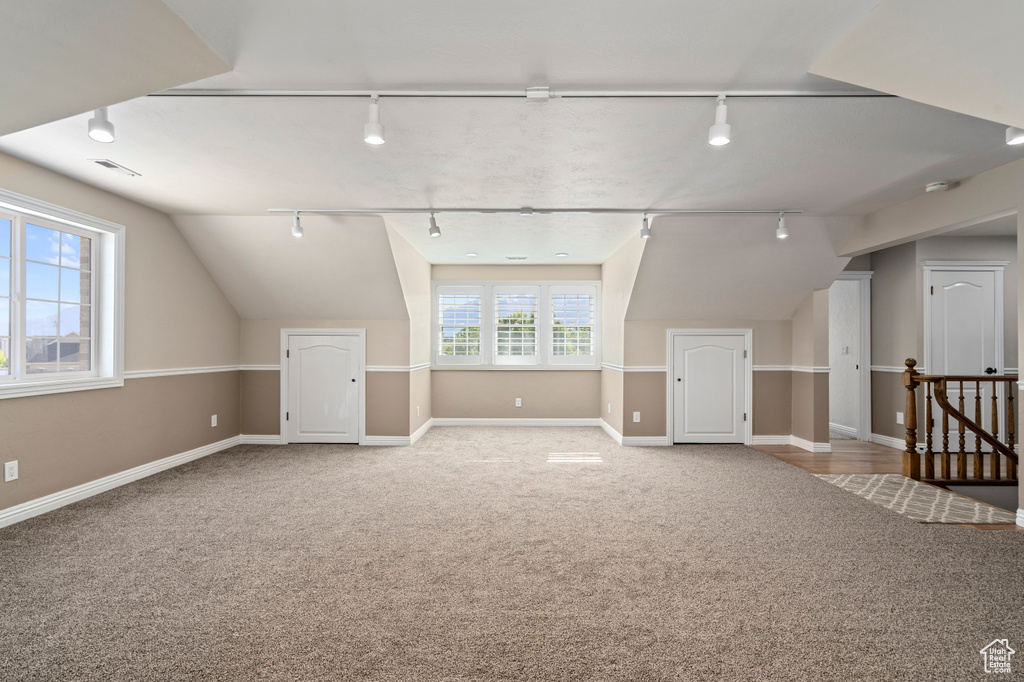 Bonus room featuring carpet floors and lofted ceiling