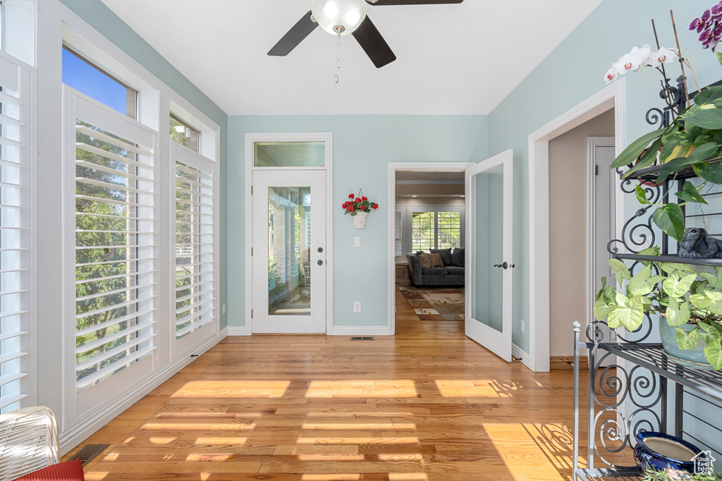 Entryway with ceiling fan and light hardwood / wood-style flooring