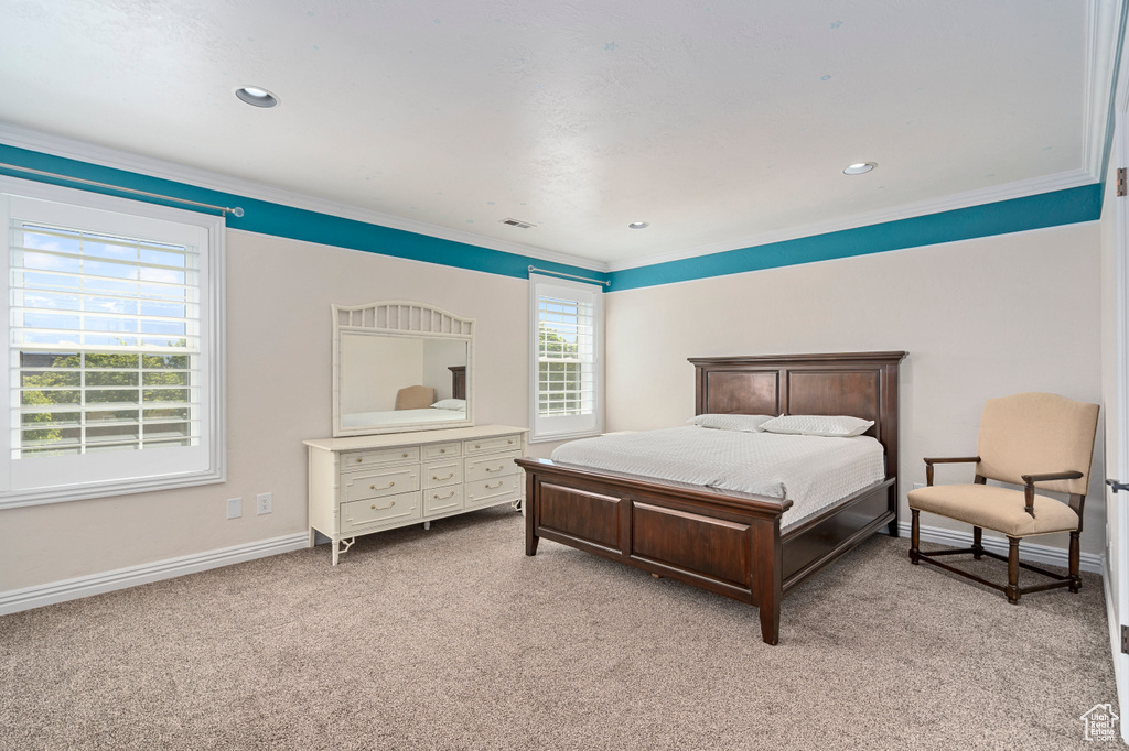 Carpeted bedroom with ornamental molding