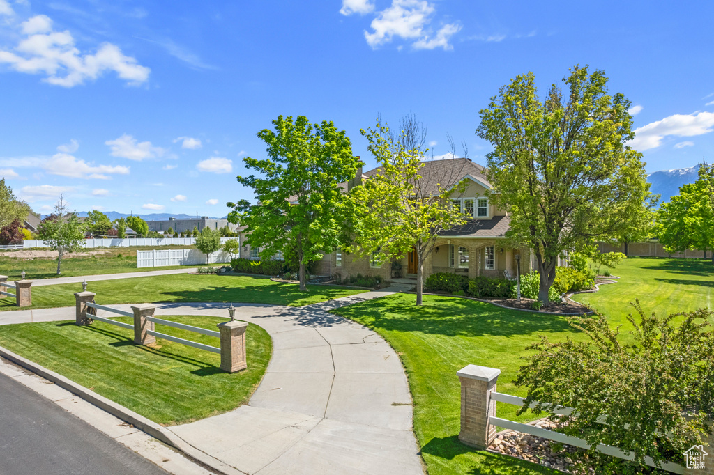 View of property's community with a lawn