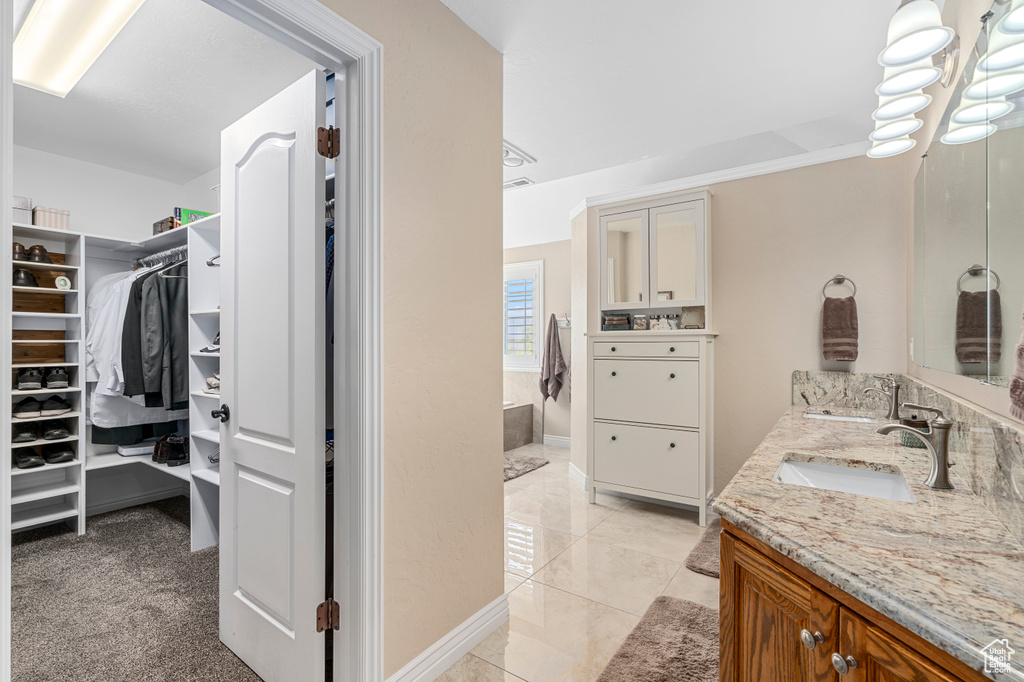 Bathroom with tile patterned floors and vanity