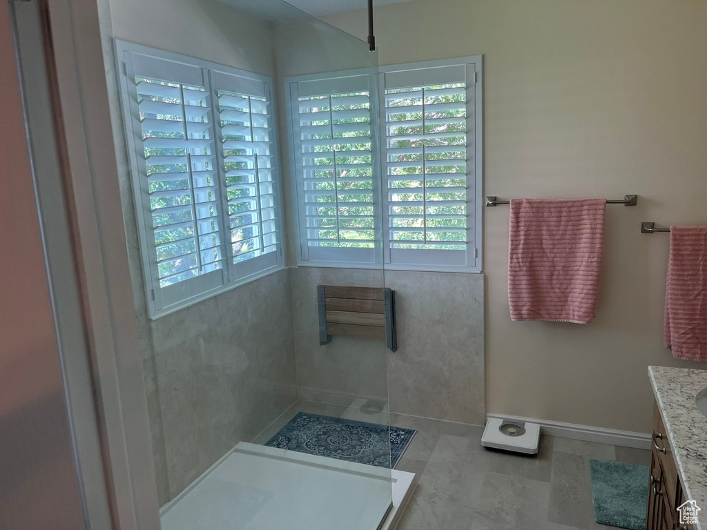 Bathroom featuring tile patterned floors, plenty of natural light, and vanity