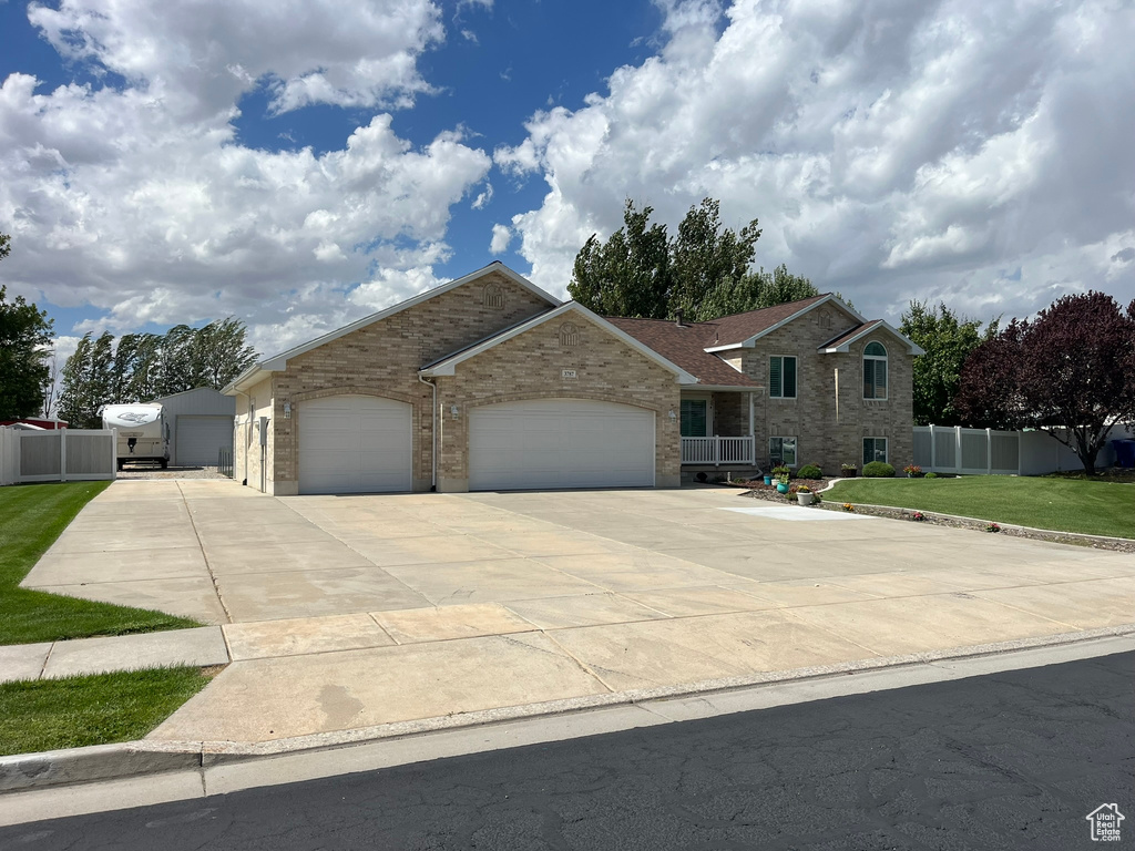 Ranch-style house featuring a garage and a front lawn